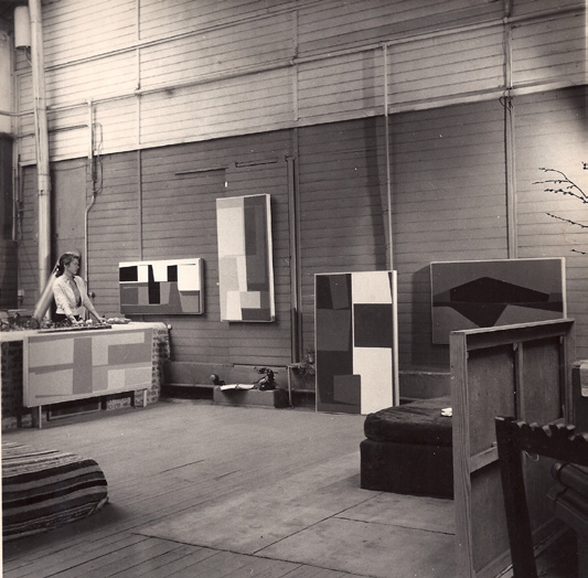 The Paris studio with paintings on the walls, Marie Zimmerman standing at left